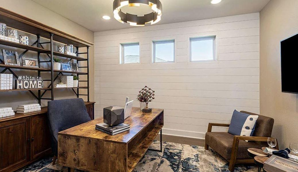 Home office with wood finished floors, wood walls, baseboards, and plenty of natural light Home office with wood finished floors, wood walls, baseboards, and plenty of natural light