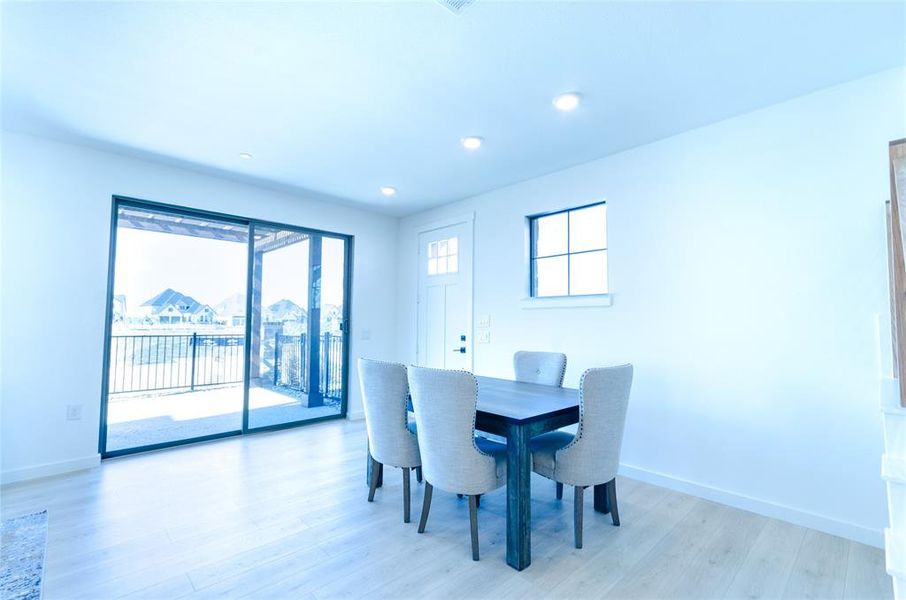 Dining space featuring light wood-style flooring and recessed lighting