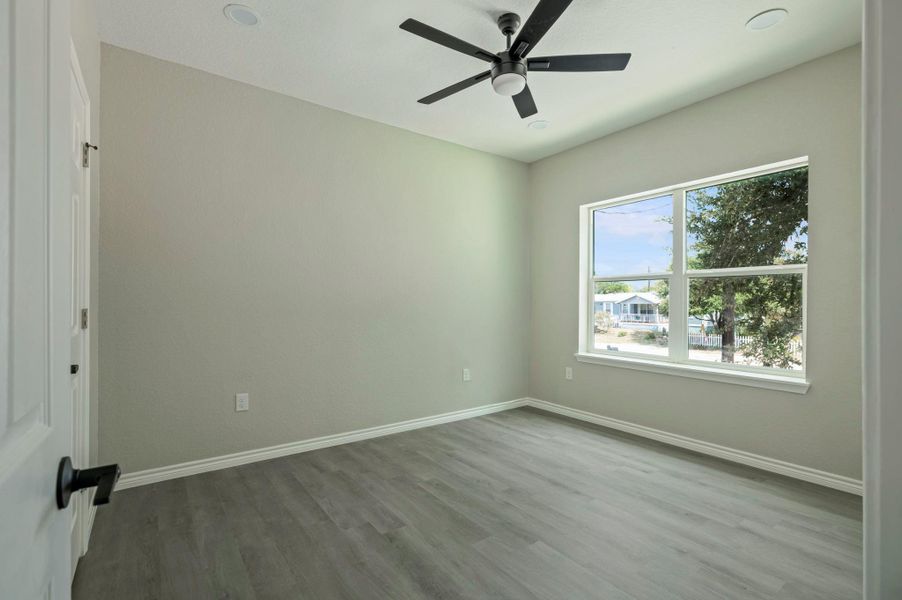 Unfurnished bedroom with wood finished floors, ceiling fan, and recessed lighting