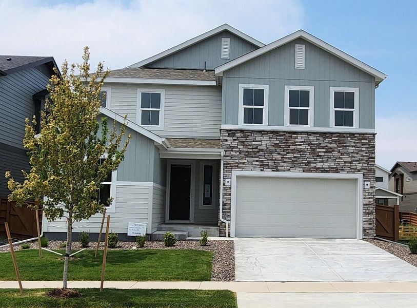 Front exterior of a new home in Reunion Ridge, Commerce City, CO, highlighting curb appeal (Image 1). Front exterior of a new home in Reunion Ridge, Commerce City, CO, highlighting curb appeal (Image 1).