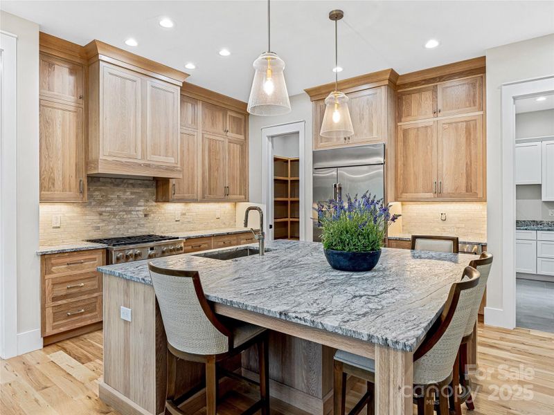 Expansive kitchen island with granite countertops Expansive kitchen island with granite countertops