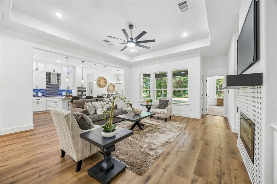 Open-concept living space featuring a trayed ceiling.
