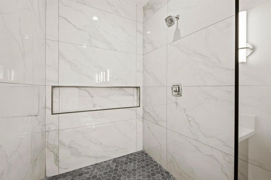 Bathroom with a marble finish shower