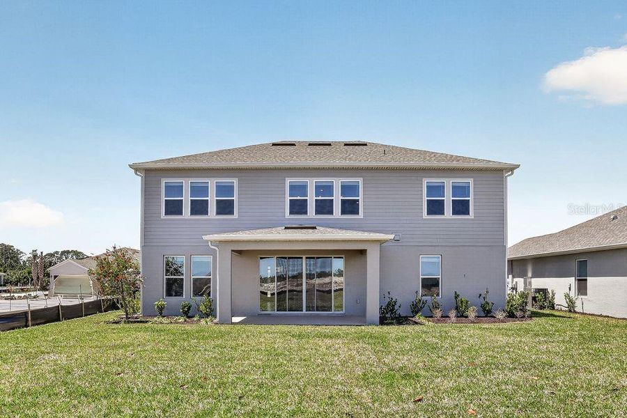 Exterior details and patio area of a home in Ardisia Park, New Smyrna Beach (Image 27).