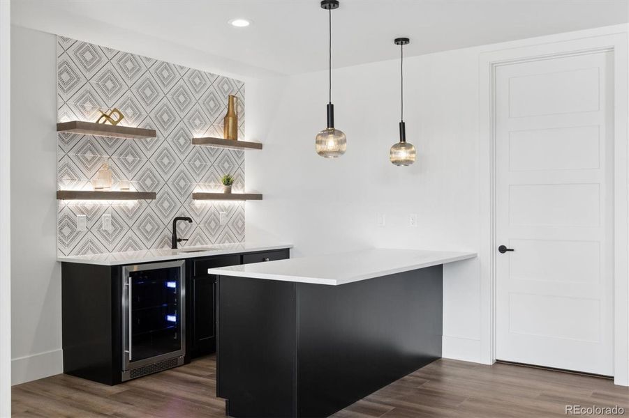 Custom lighting, shelving & bev fridge at wet bar area