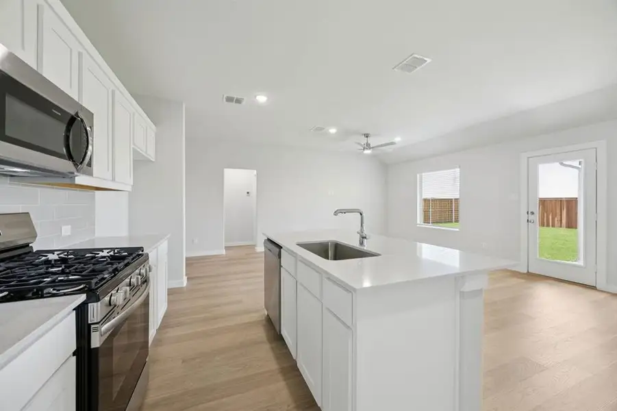 Kitchen in the Hadley home plan by Trophy Signature Homes – REPRESENTATIVE PHOTO Kitchen in the Hadley home plan by Trophy Signature Homes – REPRESENTATIVE PHOTO