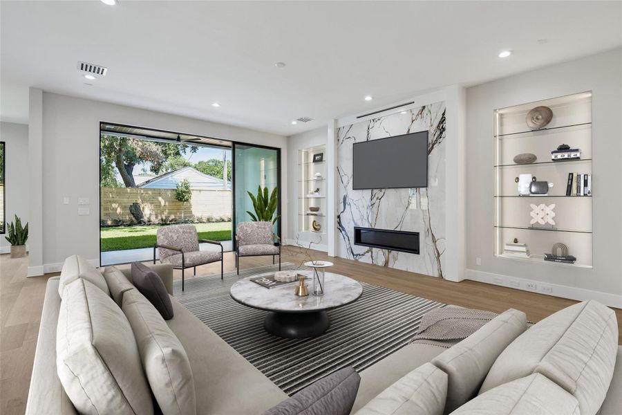 Virtually Staged. A sweeping wall of sliding glass doors brings in abundant light and creates a fluid connection to the outdoors, while the oak flooring extends into the kitchen for a cohesive, open-concept design. Virtually Staged. A sweeping wall of sliding glass doors brings in abundant light and creates a fluid connection to the outdoors, while the oak flooring extends into the kitchen for a cohesive, open-concept design.