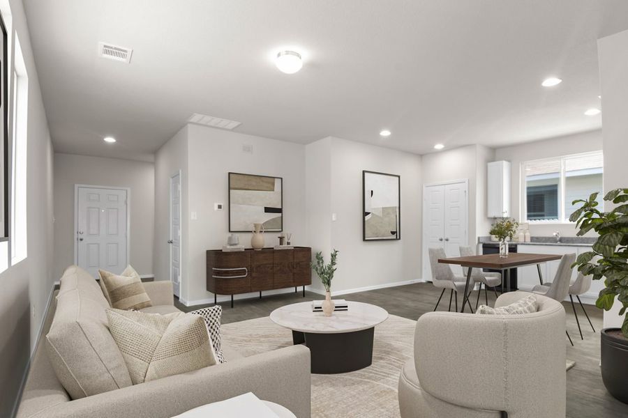 Image of a one story home staged living room with beige living room furniture with a rug and round coffee table and modern decor