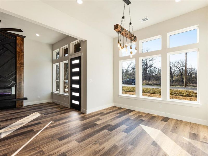 Unfurnished dining area with recessed lighting and wood finished floors