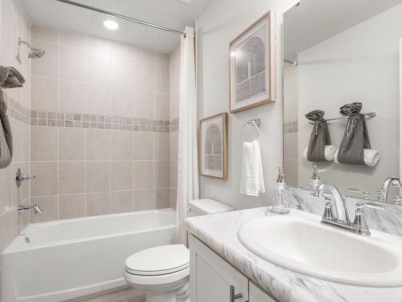 The upstairs hall bath serves the secondary bedrooms - Flora townhome by Highland Homes