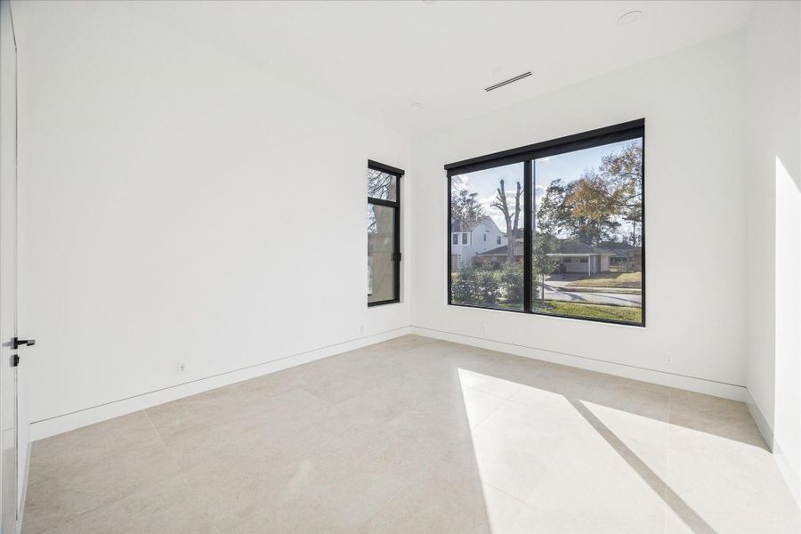 The downstairs guest room features an en-suite bath and could be a great office space as well/