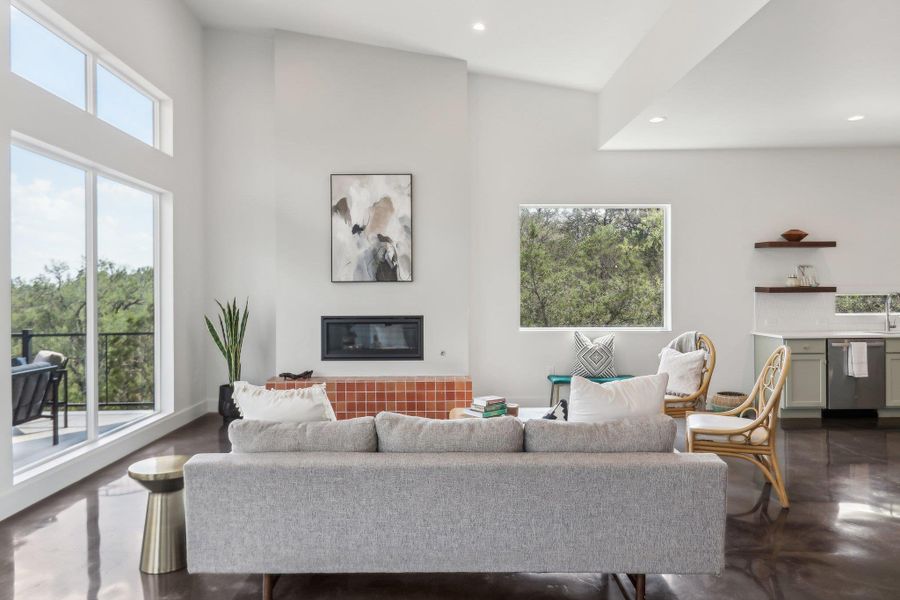 Living area with recessed lighting, a glass covered fireplace, and a towering ceiling Living area with recessed lighting, a glass covered fireplace, and a towering ceiling