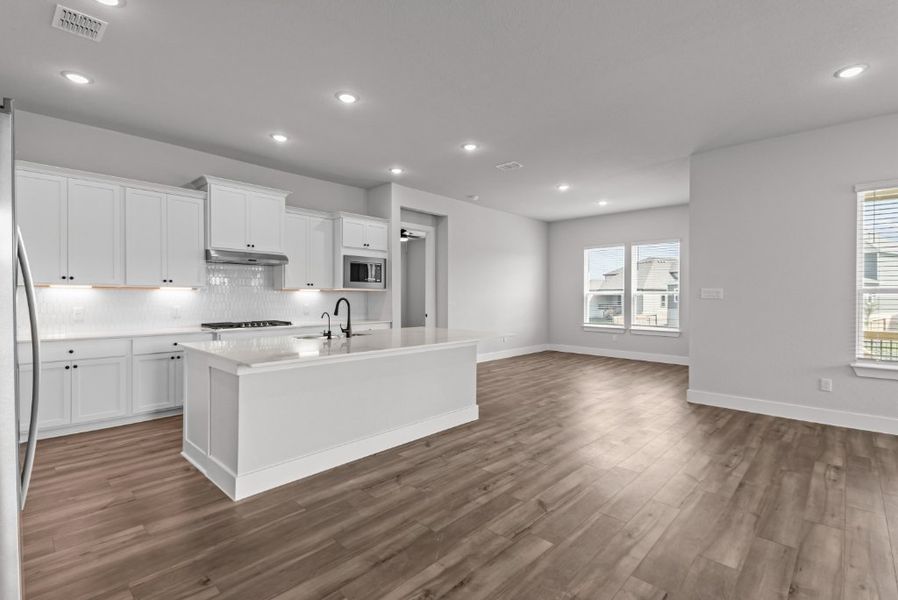 A kitchen with white cabinets.