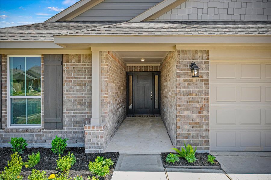 Front exterior of a new home in Grand Oaks Reserve, Cleveland, TX, highlighting curb appeal (Image 12).
