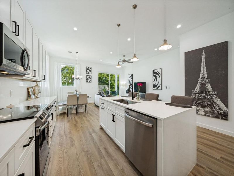 An open-concept living space integrates a well-appointed kitchen with an inviting dining and living area. An open-concept living space integrates a well-appointed kitchen with an inviting dining and living area.