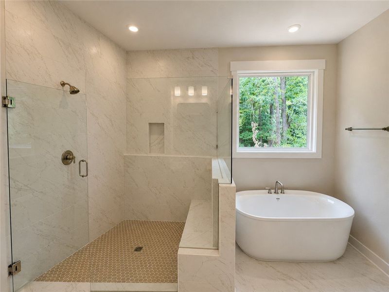 An inviting shower and tub setup with a scenic, tr