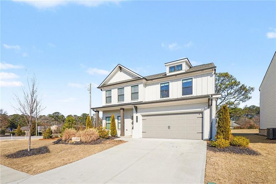 Front exterior of a new home in Westgate Estates, Loganville, GA, highlighting curb appeal (Image 2). Front exterior of a new home in Westgate Estates, Loganville, GA, highlighting curb appeal (Image 2).