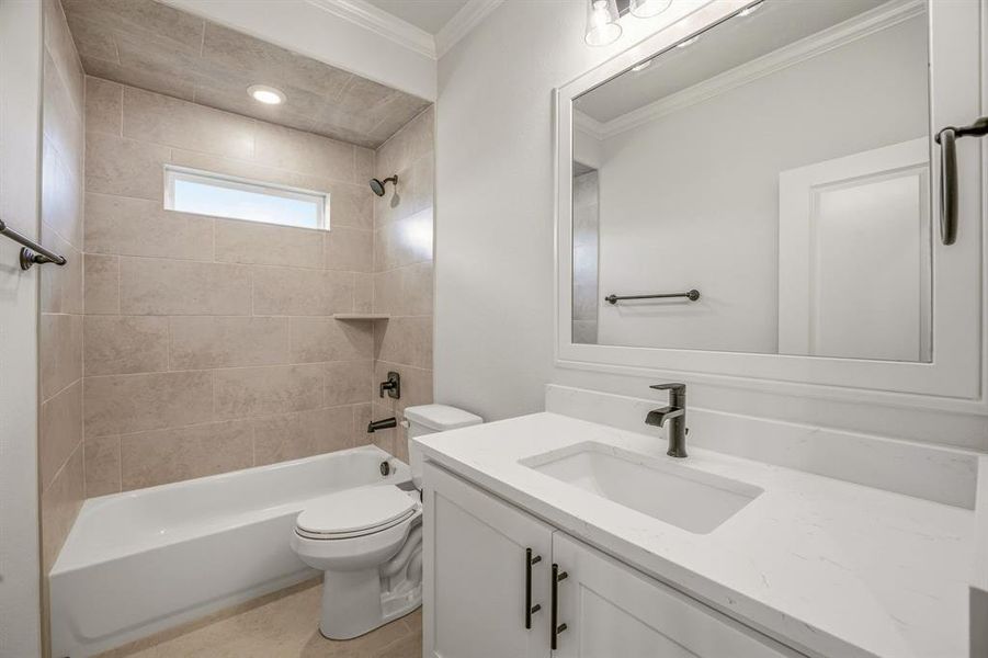 Bathroom featuring vanity, washtub / shower combination, ornamental molding, and recessed lighting