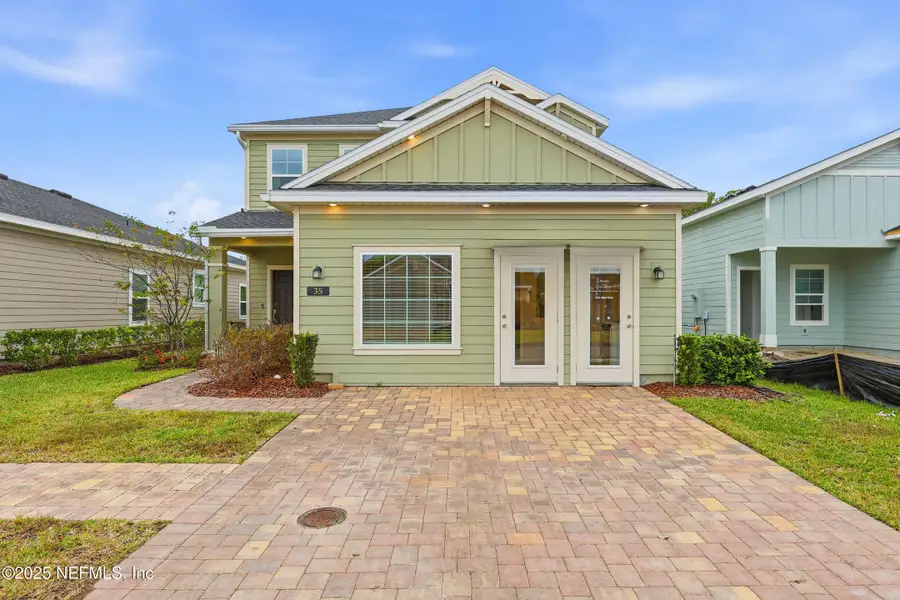 Front exterior of a new home in St Augustine Lakes: St Augustine Lakes 40S, St. Augustine, FL, highlighting curb appeal (Image 1).