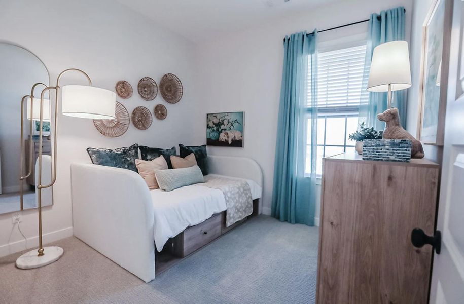 Bright interior space featuring light-toned carpeting and white walls