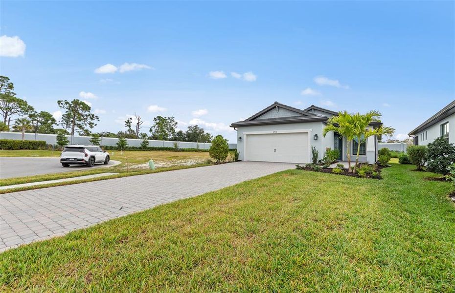Front exterior of a new home in Arbor Oaks, North Port, FL, highlighting curb appeal (Image 19). Front exterior of a new home in Arbor Oaks, North Port, FL, highlighting curb appeal (Image 19).