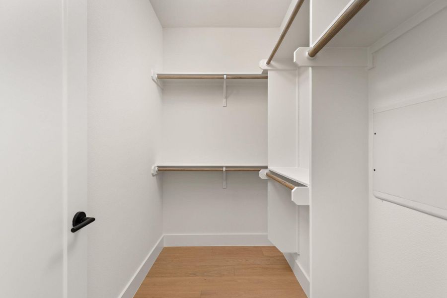 Ample shelving and hanging space defines this organized, well-appointed closet.