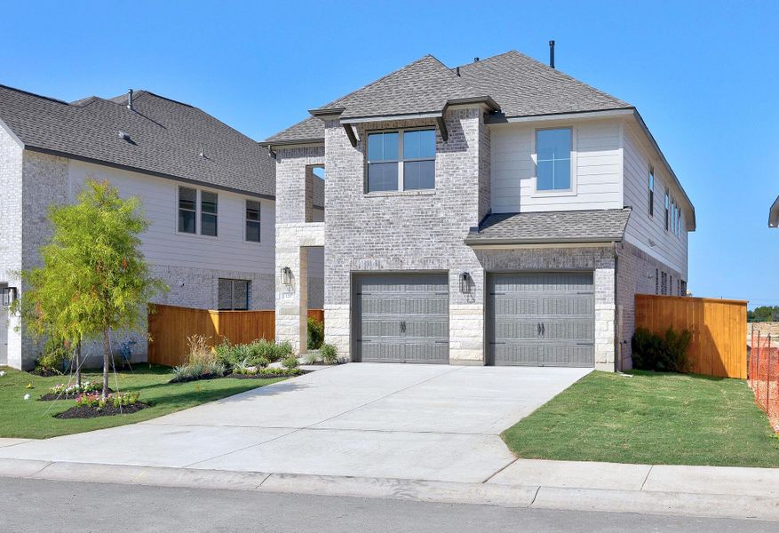 Front exterior of a new home in Parmer Ranch, Georgetown, TX, highlighting curb appeal (Image 22). Front exterior of a new home in Parmer Ranch, Georgetown, TX, highlighting curb appeal (Image 22).
