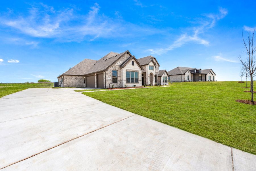 Front exterior of a new home in Berkshire Estates, Mesquite, TX, highlighting curb appeal (Image 24).