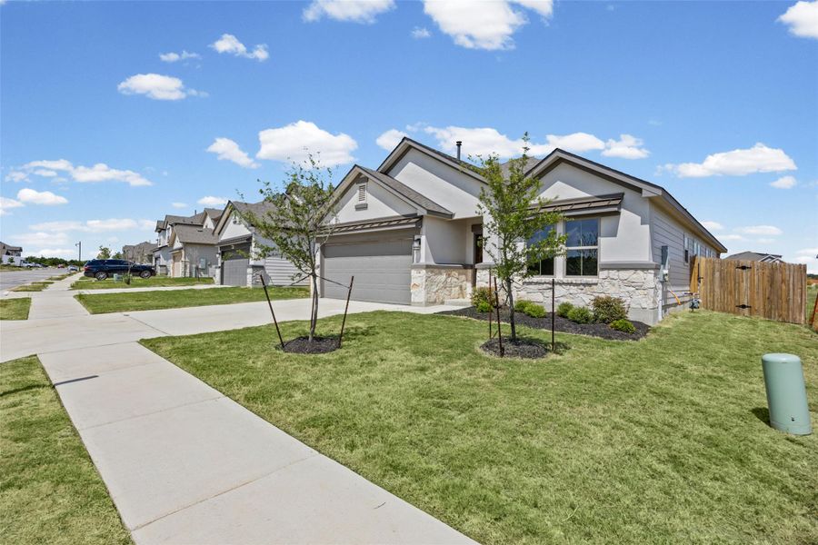 New construction home with stone accent and full landscaping. New construction home with stone accent and full landscaping.