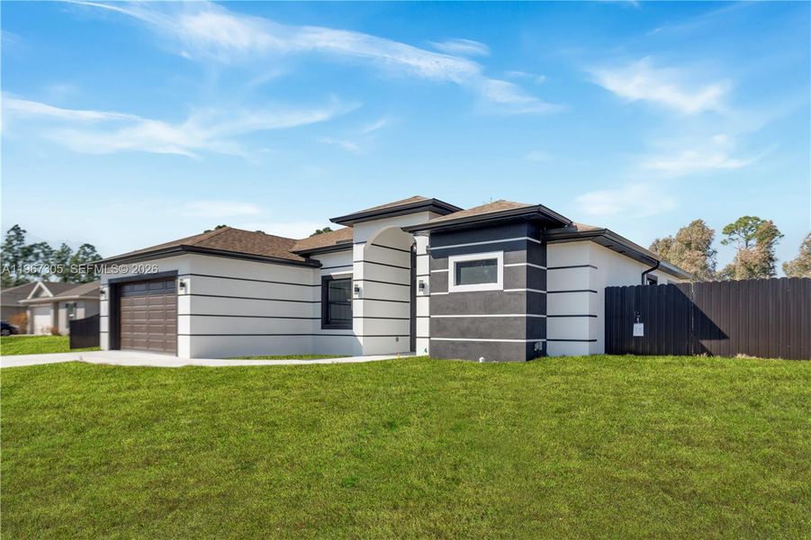 Front exterior of a new home in , Lehigh Acres, FL, highlighting curb appeal (Image 22).
