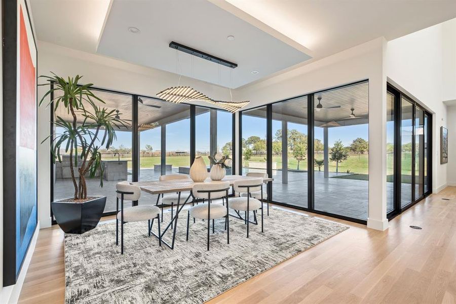 Stylish dining space overlooking the backyard and pool. Stylish dining space overlooking the backyard and pool.