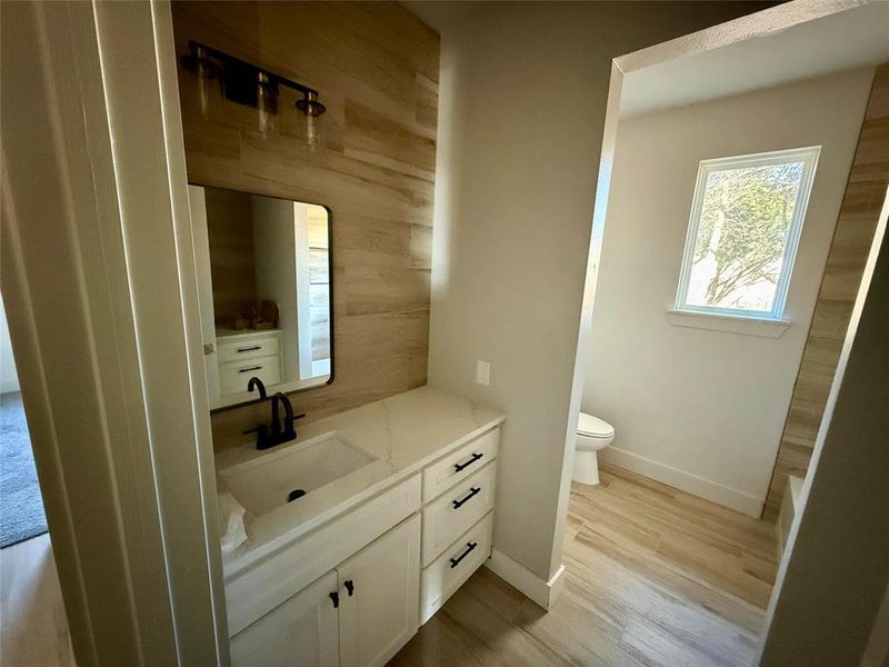 Guest Bathroom with vanity and light wood finished floors