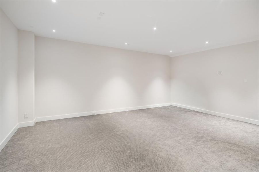 Oversized media room designed for the ultimate movie night experience, featuring upgraded low-profile carpet and a dedicated AV closet. Pre-wired for surround sound speakers, projector, and screen, this expansive space is ready to be transformed into the perfect home theater.