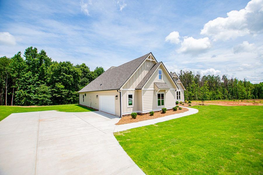 Front exterior of a new home in WOODMONT RESERVE, Roopville, GA, highlighting curb appeal (Image 29).