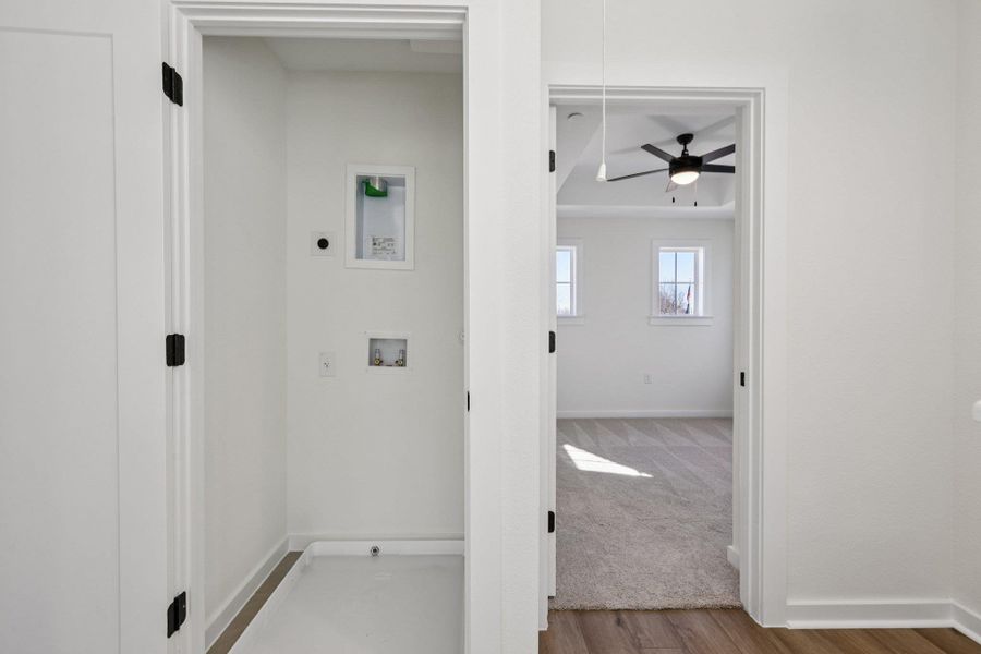 Corridor with light wood finished floors and baseboards
