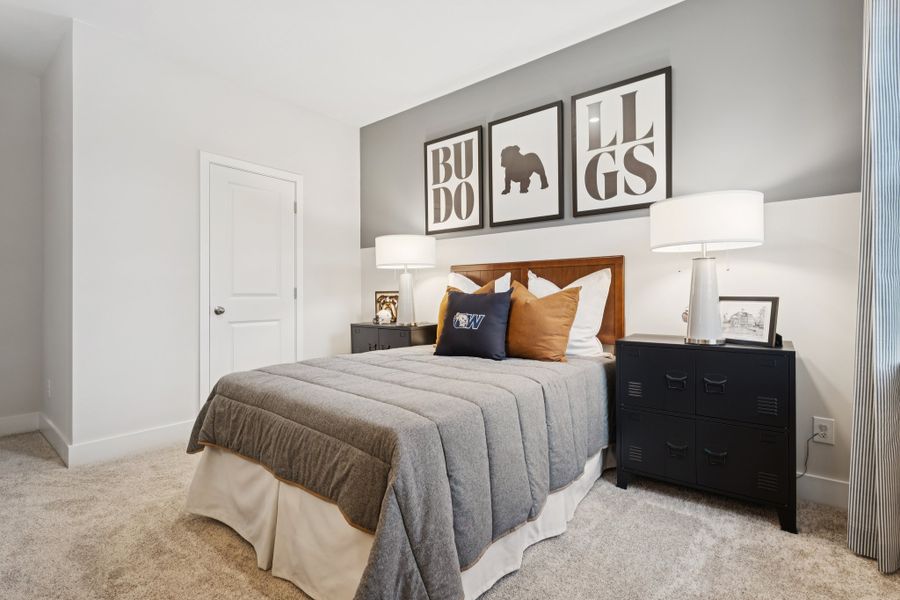 A bedroom with a bed and lamps.