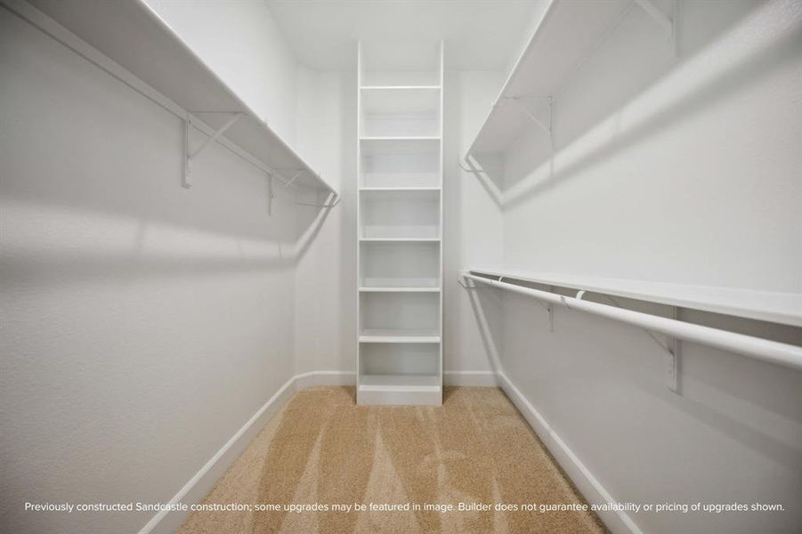 Space for Everything: Miles of hang space and custom shelves adorn boatloads of storage across two distinct primary closets.