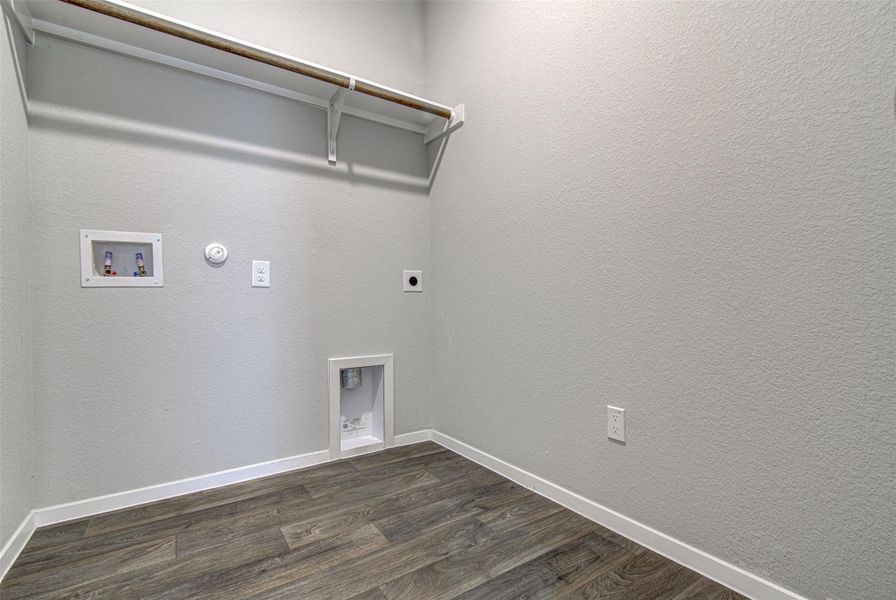 A dedicated utility space, providing essential connections for laundry appliances and a convenient overhead shelf. A dedicated utility space, providing essential connections for laundry appliances and a convenient overhead shelf.
