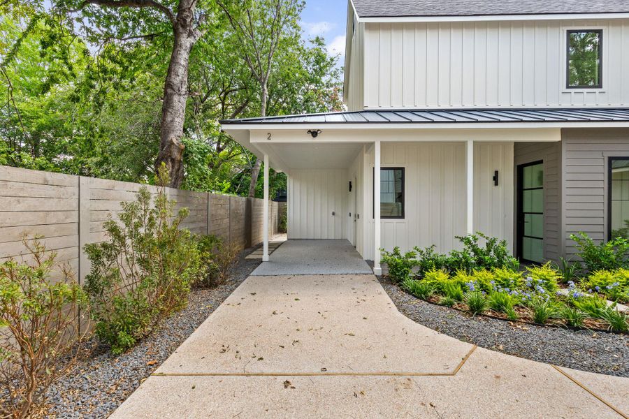 Entrance to property with board and batten siding, roof with shingles, a metal roof, a carport, and a porch Entrance to property with board and batten siding, roof with shingles, a metal roof, a carport, and a porch