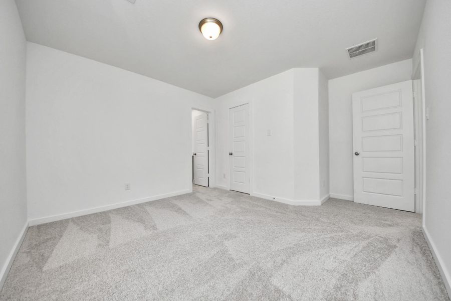 Generously sized secondary bedrooms featuring spacious closets, soft and inviting carpeting underfoot, large windows allowing plenty of natural light, and the added touch of privacy blinds for your personal retreat. Sample photo of completed home with similar floor plan. Actual colors and selections may vary.