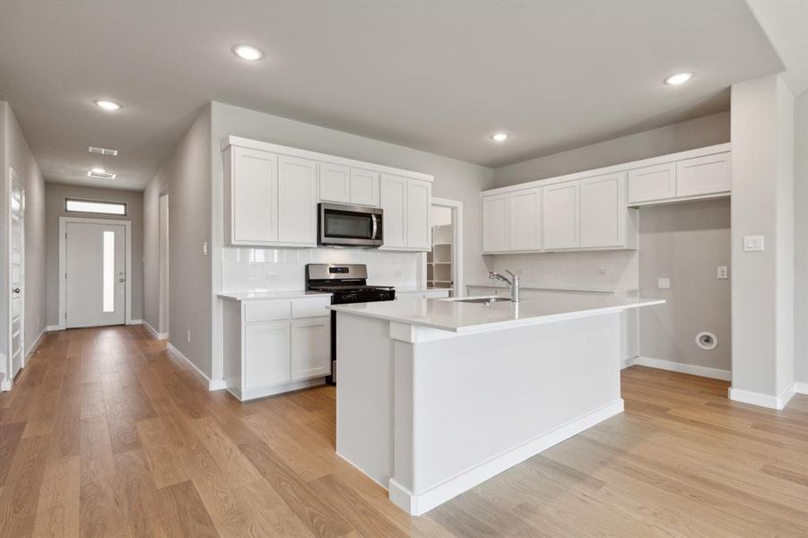 Kitchen in the Masters home plan by Trophy Signature Homes – REPRESENTATIVE PHOTO