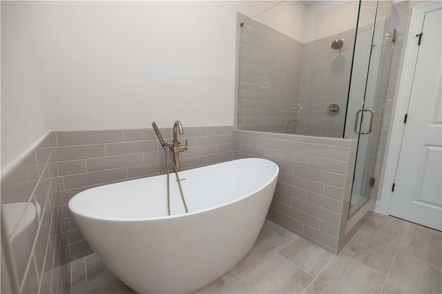 Bathroom with independent shower and bath and tile walls