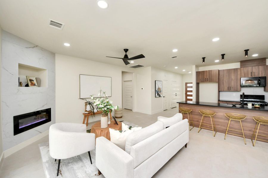 The heart of the home features a sleek electric fireplace with remote control for instant ambiance
