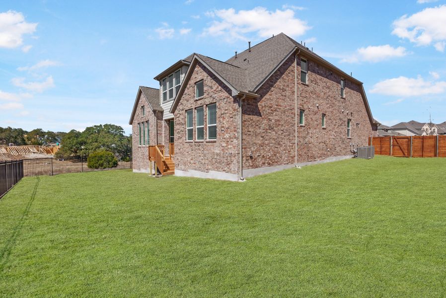 Representative exterior photo of a completed home built from the Hasley by Ashton Woods in The Estates at La Cima, San Marcos, TX (Image 17).