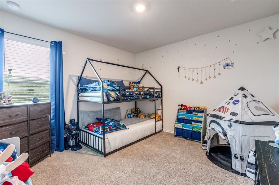 Bedroom featuring light carpet Bedroom featuring light carpet
