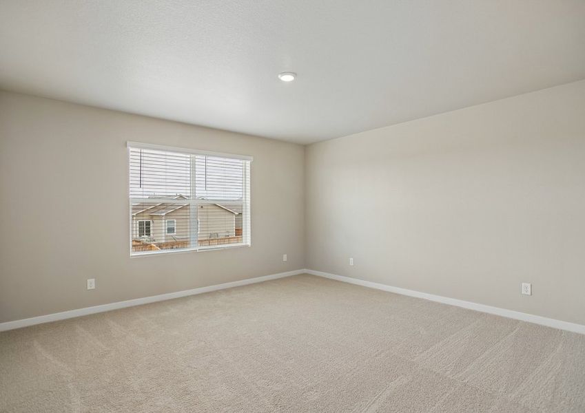 The master bedroom is spacious with large windows.