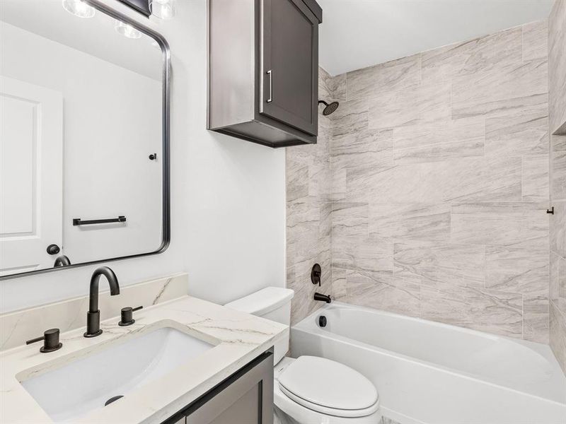 Full bath featuring tub / shower combination and vanity