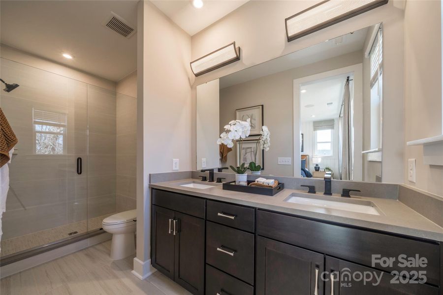 Primary En Suite Bath Hosting Dual Vanity and Walk-In Shower. Primary En Suite Bath Hosting Dual Vanity and Walk-In Shower.