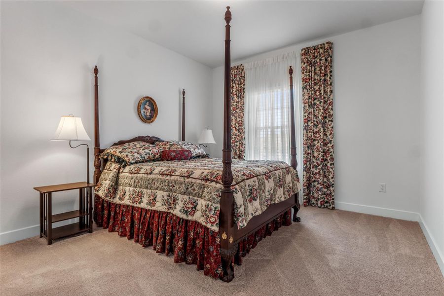 Bedroom 4 with light colored carpet and baseboards Bedroom 4 with light colored carpet and baseboards