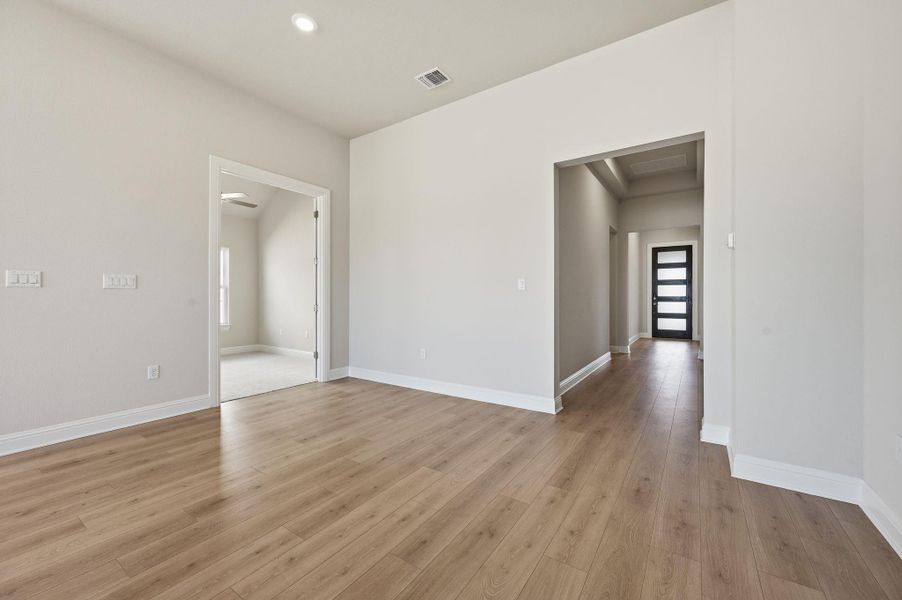 Empty room with light wood-type flooring and recessed lighting Empty room with light wood-type flooring and recessed lighting